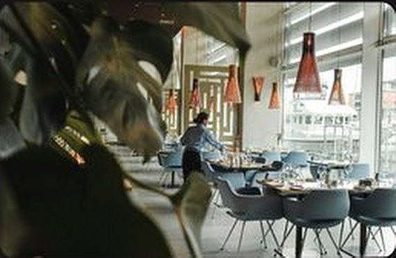A bright restaurant dining room set for service