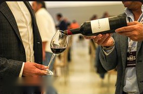 A sommelier presenting and pouring a bottle for a guest